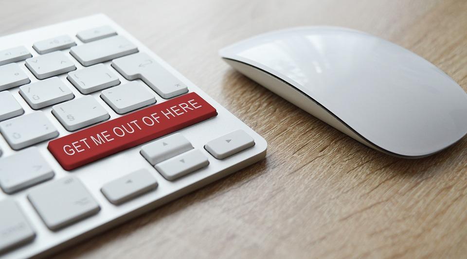 a computer keyboard with a red button that says get me out of here