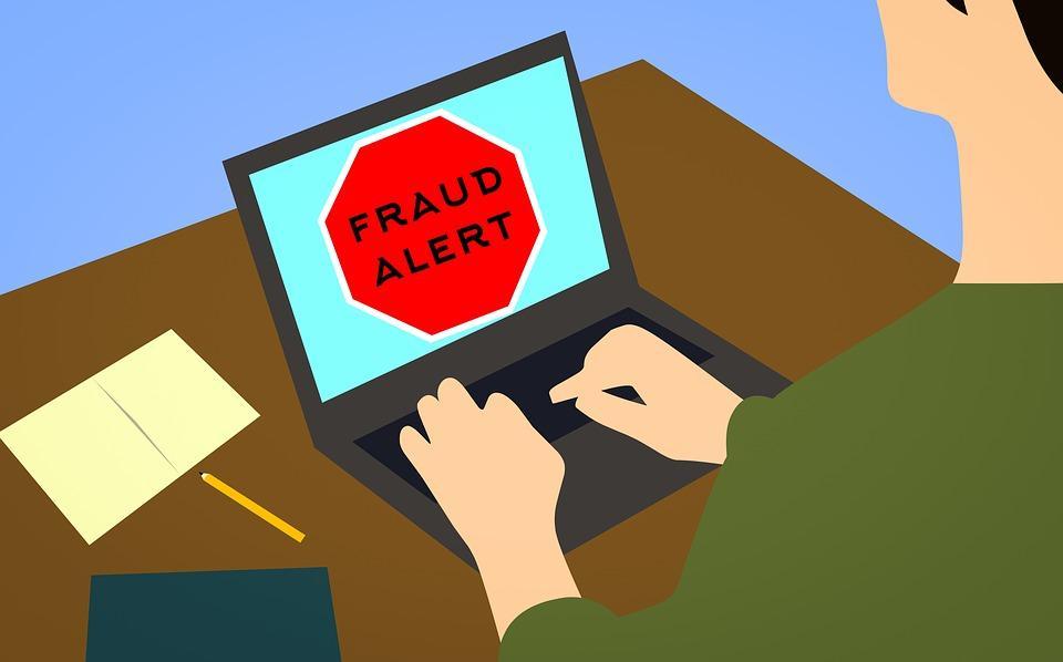 a person using a laptop with a red stop sign on the screen