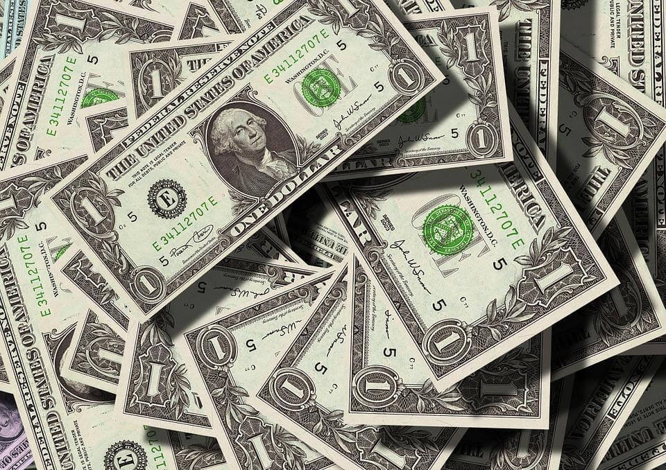 a pile of twenty dollar bills sitting on top of each other
